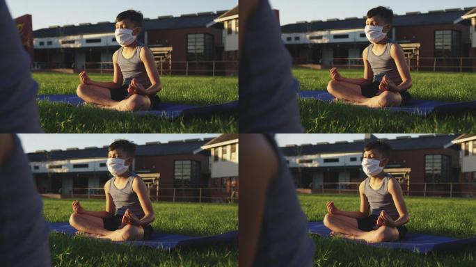男孩戴着面具在花园里做瑜伽