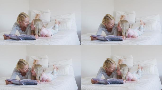 一个白人妇女在床上给她的女儿读故事的侧面