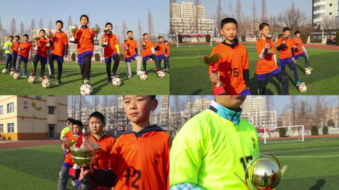 冬天运镜拍摄少年足球队员手拿奖杯