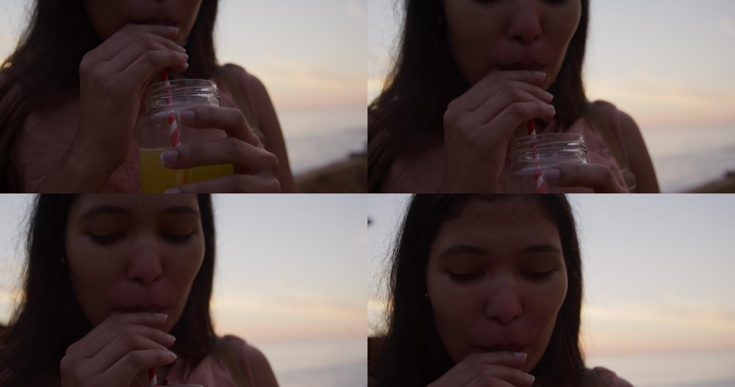 年轻女子在喝冰沙冰饮喝饮料喝橙汁