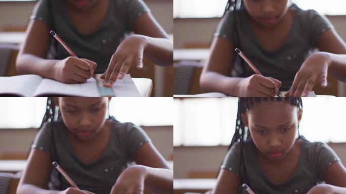一个女孩坐在她的课桌上用比例画了一条线