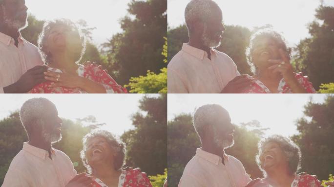 一个高级非洲裔美国夫妇花时间在一起在花园里相爱