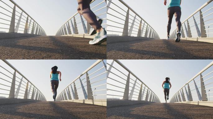 年轻女子在桥上跑步