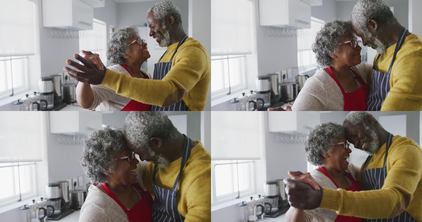 一对非裔美国老年情侣在家跳舞。隔离期间的社交距离