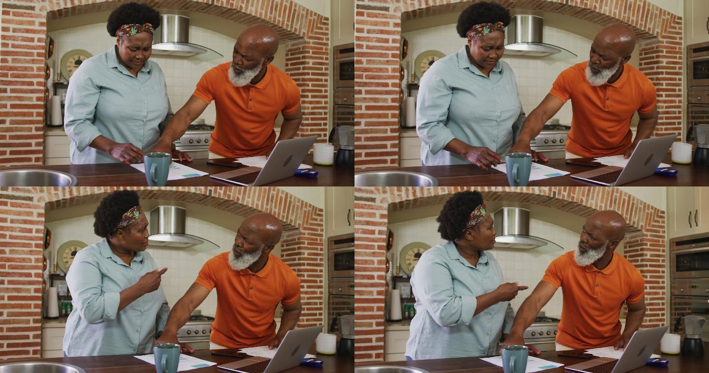 一对非洲裔美国老年夫妇在家里的厨房里讨论账单