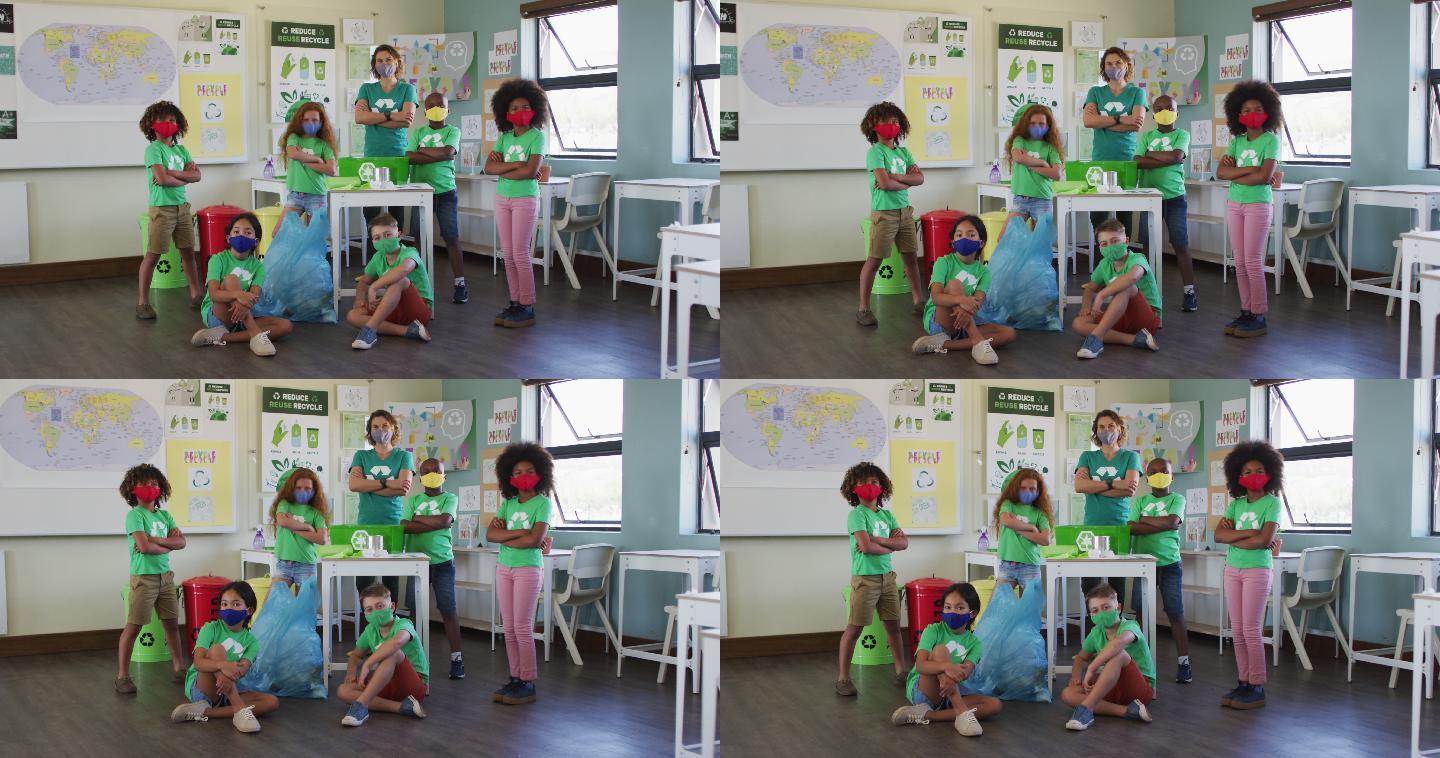 女老师和一群穿着回收标志t恤的孩子在课堂上
