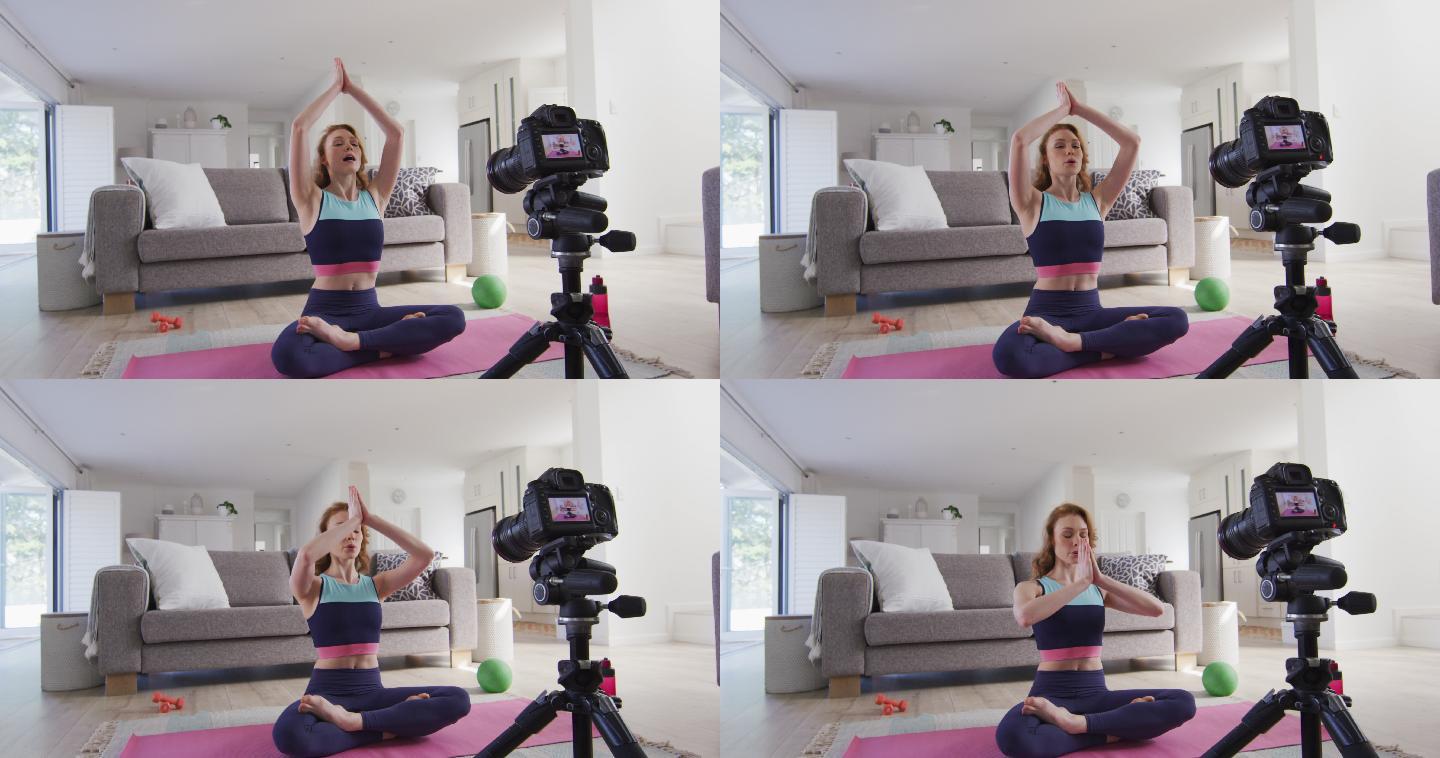 女人在家里练习瑜伽，并用数码相机记录下来