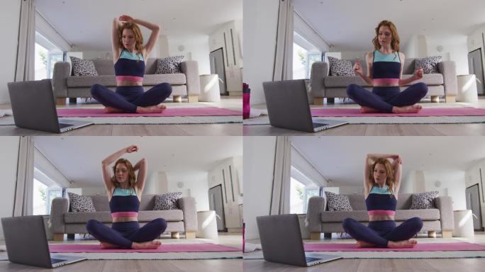 在家里一边练瑜伽一边看笔记本电脑