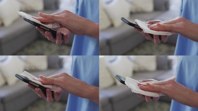 女性卫生工作者用纸巾擦拭智能手机