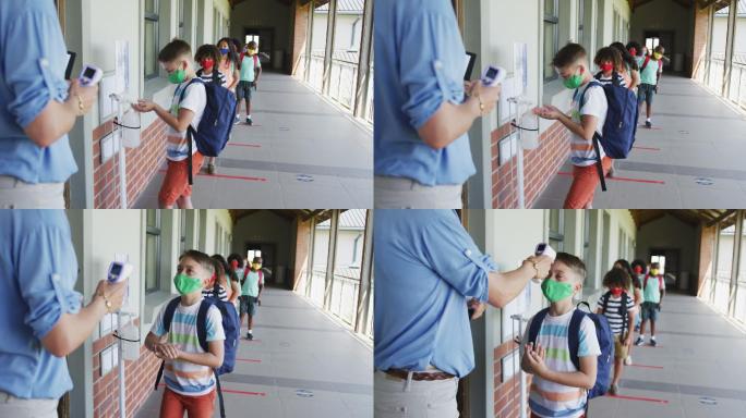 男孩戴着口罩在学校给手消毒