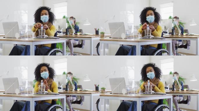 一名妇女戴着口罩在办公室给双手消毒