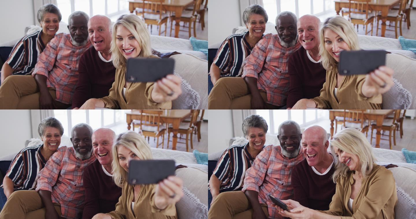 两对不同的老年夫妇坐在沙发上用智能手机自拍