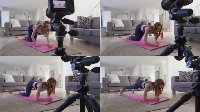 女人在家里做平板支撑运动，并用数码相机记录下来