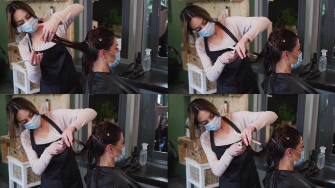 女理发师戴着口罩在美发沙龙为女顾客理发