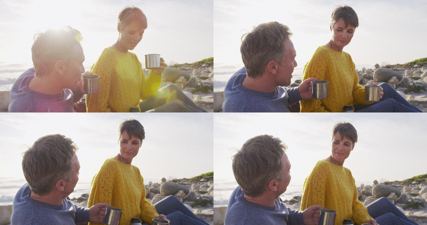 在阳光明媚的日子里，白种夫妇享受着海上的自由时间，喝着咖啡