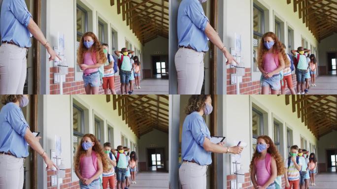 女老师戴着口罩检查在校女生的体温