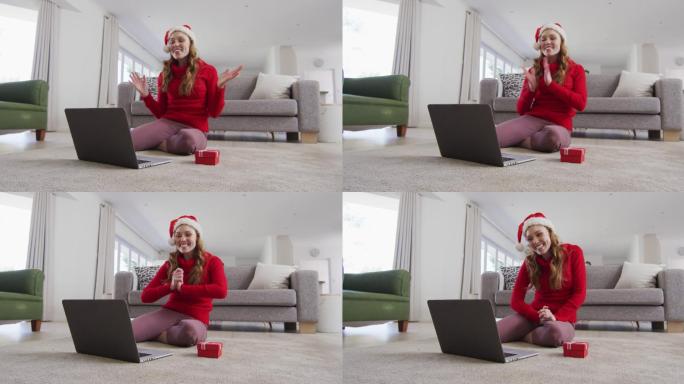 戴圣诞帽的女人正在家里用笔记本电脑视频聊天