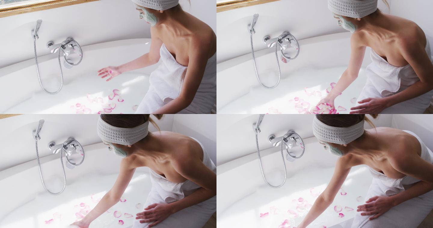 一个女人敷着面膜，在浴缸里撒玫瑰花瓣