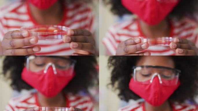 戴面罩和防护眼镜的女孩在实验室拿着装有化学品的容器