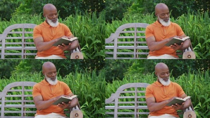 一位非裔美国老人坐在花园里的长凳上看书