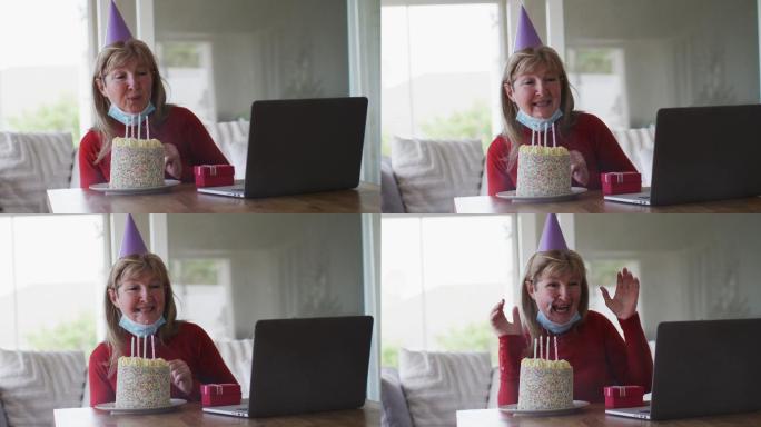 老女人一边吹蛋糕一边在家里用笔记本电脑视频聊天
