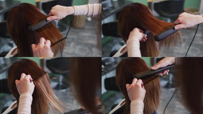 女发型师在美发沙龙为女性顾客拉直头发
