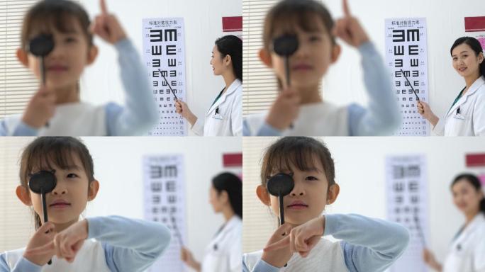 验光师给小女孩测试视力
