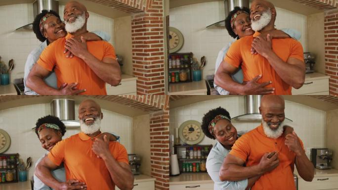 一对非裔美国老年夫妇在自家厨房里拥抱