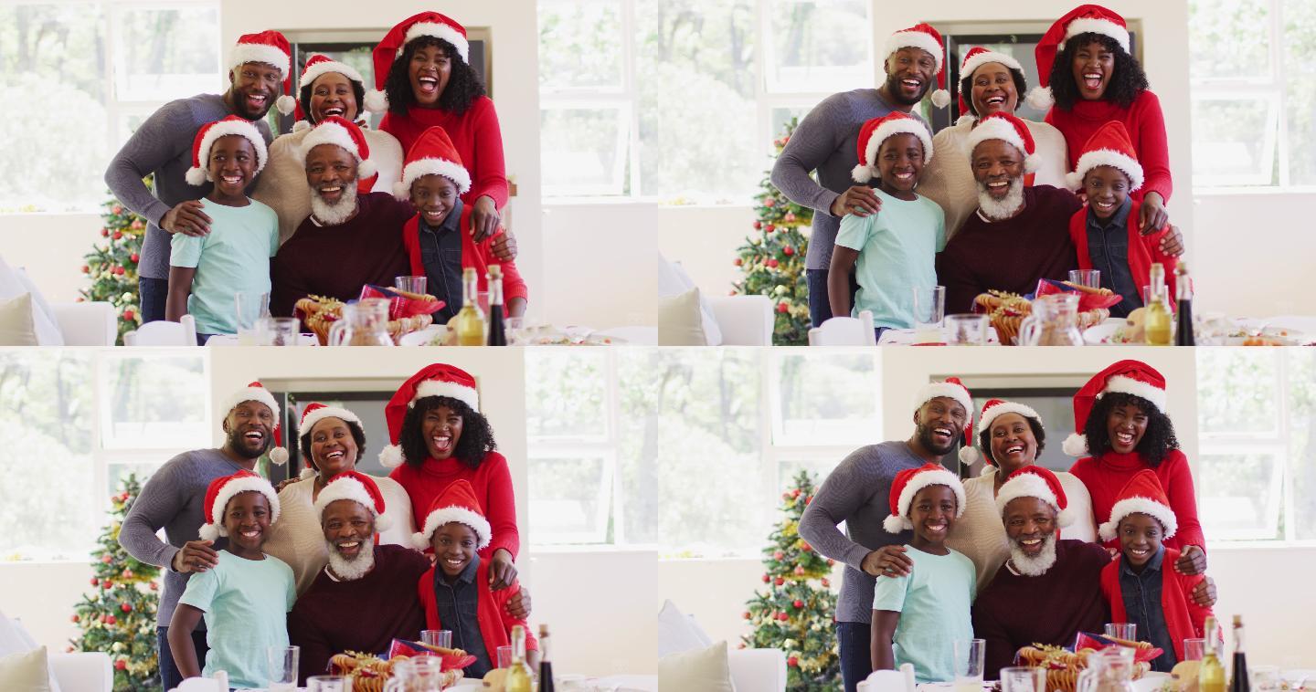 非裔美国家庭戴着圣诞帽在家一起微笑的肖像