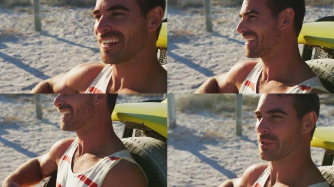 快乐的白人男子坐在海边的沙滩车弹吉他