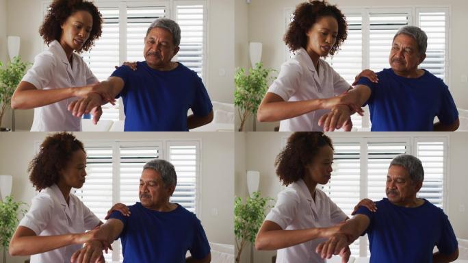 混血女理疗师帮助年长男子伸展手臂
