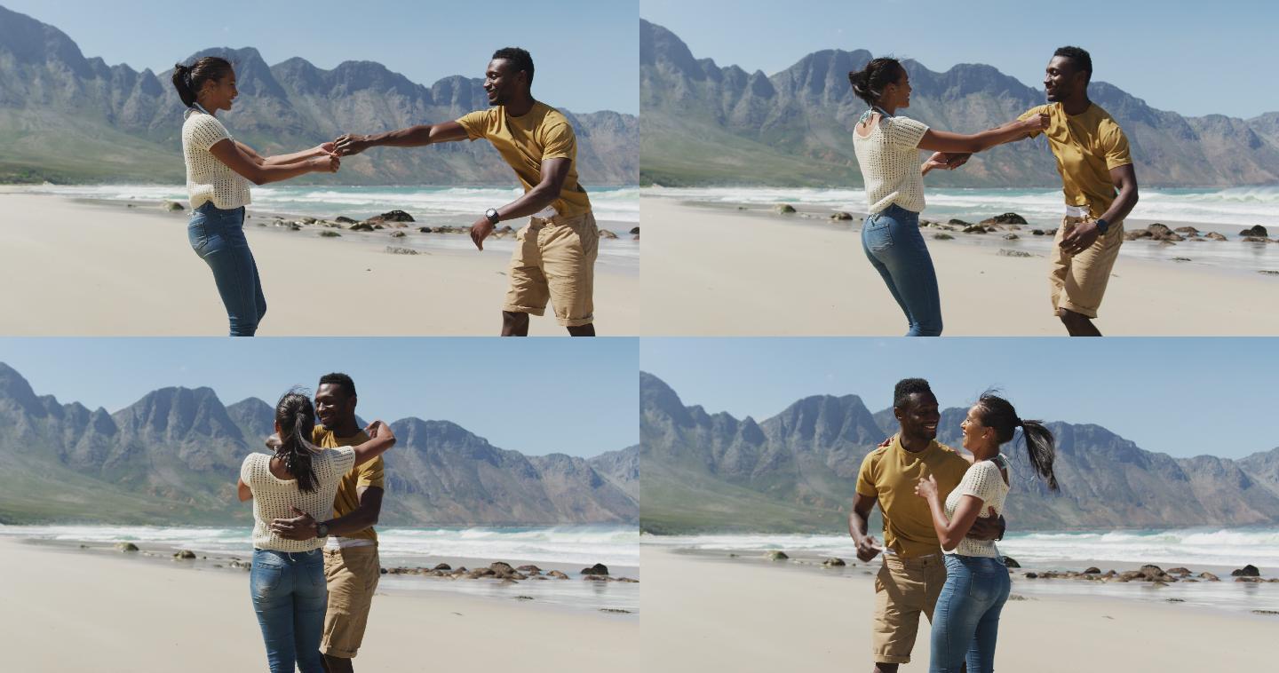 快乐的非裔美国人情侣在海滩上一起跳舞