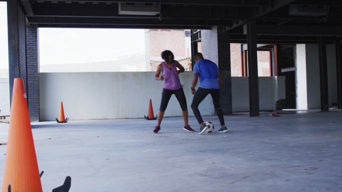 非裔美国人在一座空的城市建筑里踢足球
