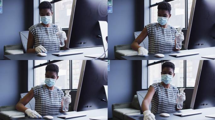 非裔美国妇女戴着口罩和手套，清洁她的工作站