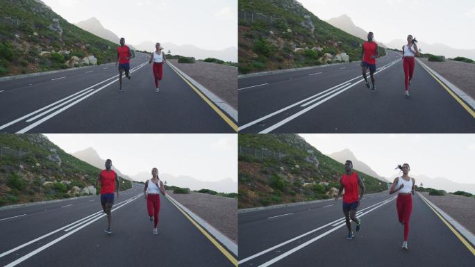 不同的健康夫妇锻炼跑步在一个乡村道路附近的山