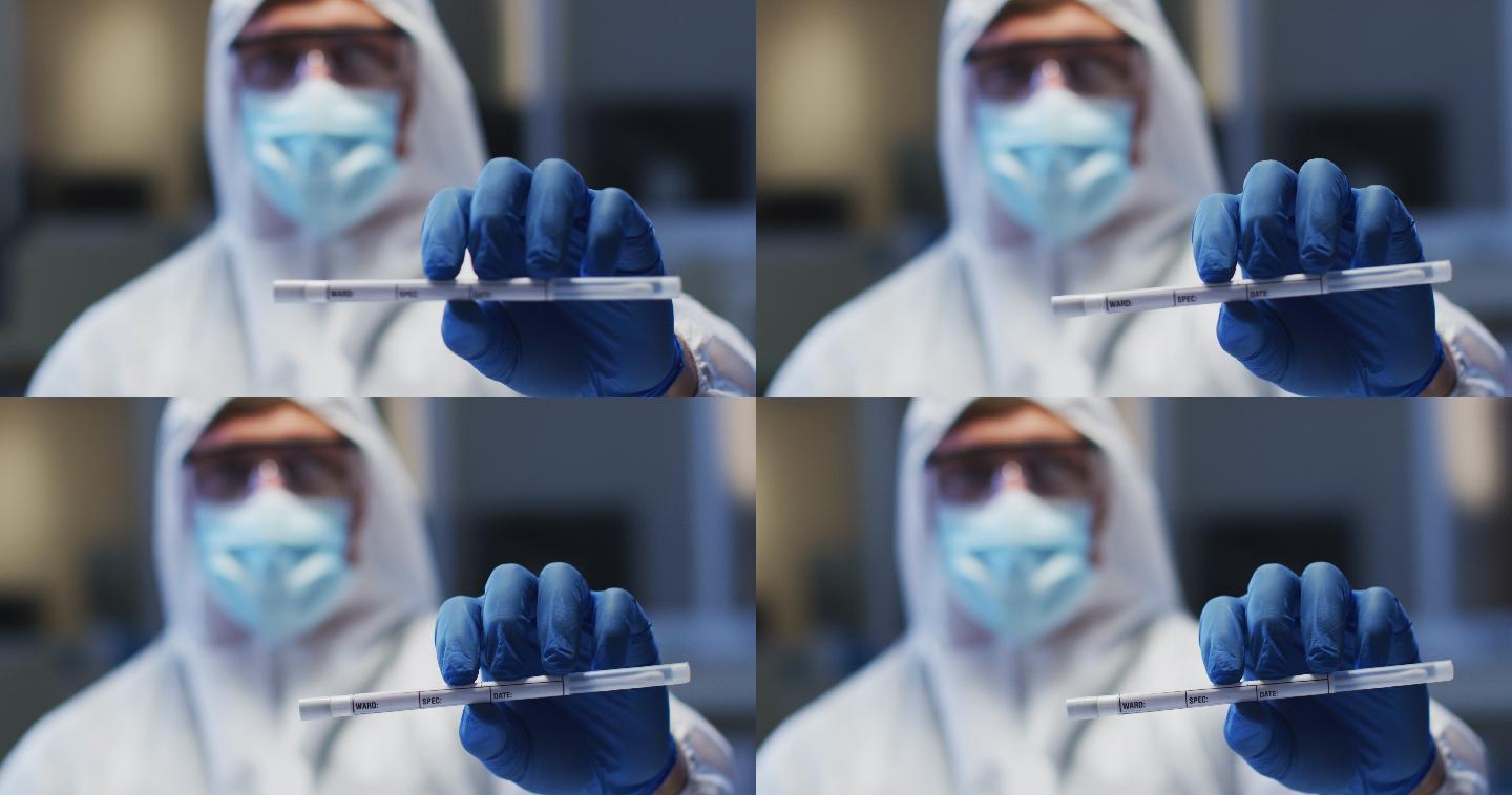 白种男性医务工作者，穿着防护服，戴着口罩和手套，在实验室里拿着dna拭子