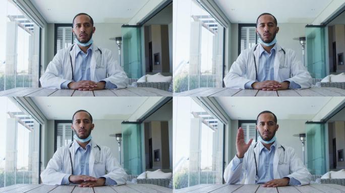 混血男医生戴着面具在视频通话中交谈