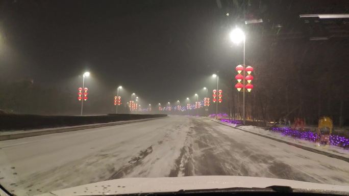 雪天在路灯白雪道路行驶