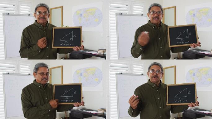 混血男教师站在白板前给摄像机上在线课程