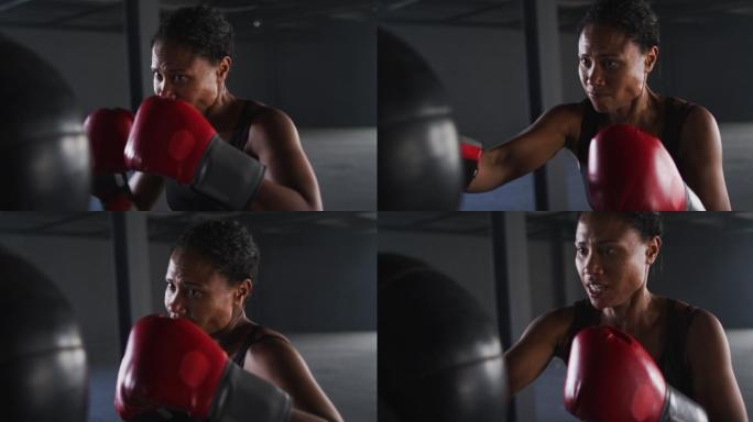 非洲裔美国妇女戴着拳击手套在空的建筑物训练出拳沙袋