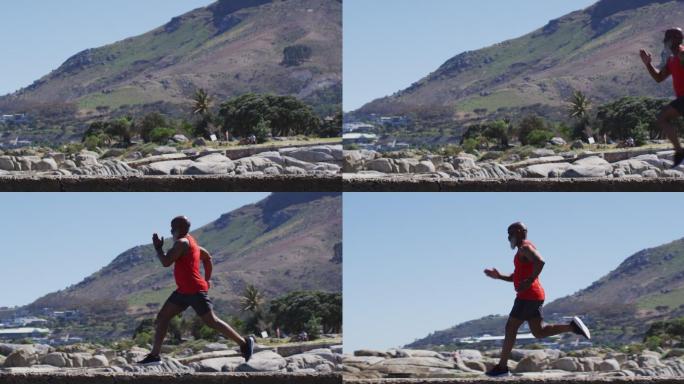一位年长的非洲裔美国人正在海边的岩石上练习跑步