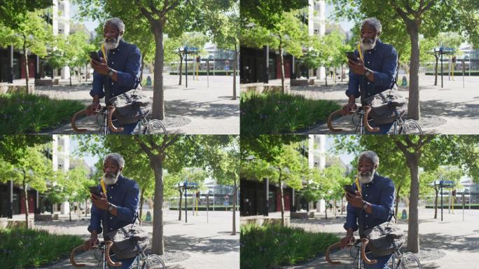 非裔美国老人骑着自行车在路上使用智能手机