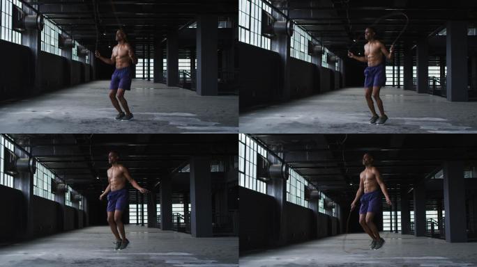 赤裸上身的非裔美国人在一座空的城市建筑里跳绳