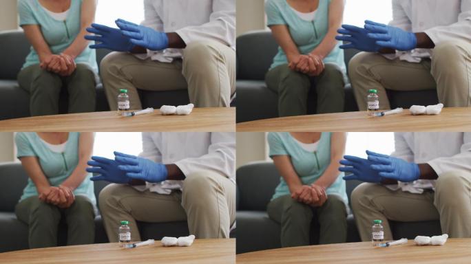 非裔美国男医生在注射covid-19疫苗前与女患者交谈的中段