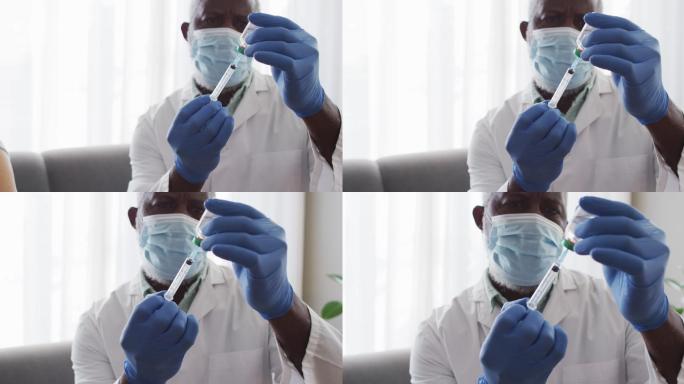男非裔美国医生戴口罩，将covid-19疫苗放入注射器