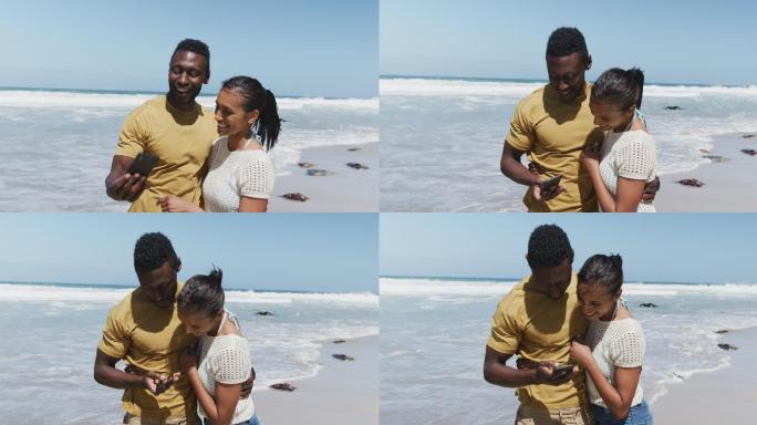 快乐的非裔美国夫妇在海滩用智能手机自拍