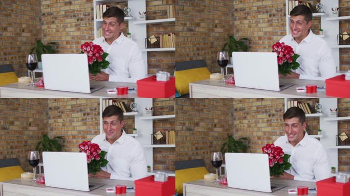 一名白人男子拿着一束鲜花微笑着用笔记本电脑进行视频通话