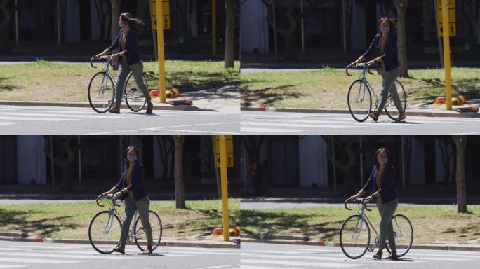 非洲裔美国妇女戴着口罩骑着自行车过马路