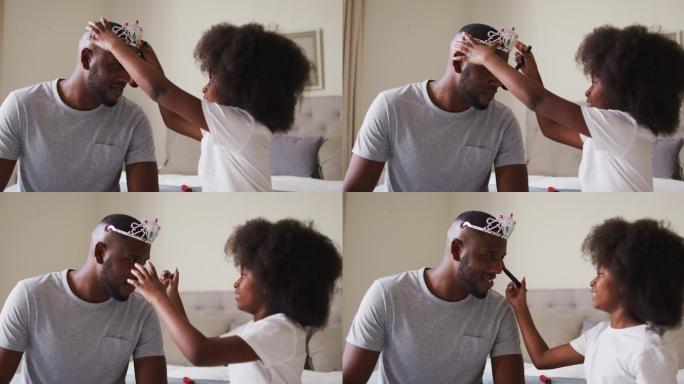 非裔美国父亲戴着头冠，让女儿化妆