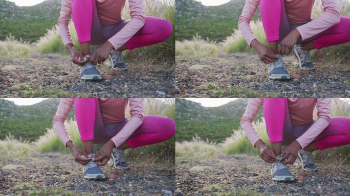 低段的混合种族妇女在农村练习系鞋带